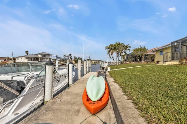 dock area with a yard and a water view