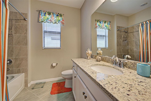 full bathroom with plenty of natural light, vanity, tile patterned flooring, and toilet