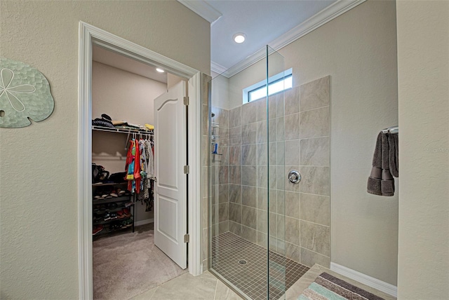 bathroom featuring tile patterned floors, ornamental molding, and tiled shower