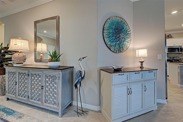 interior space featuring appliances with stainless steel finishes and crown molding