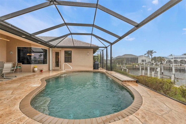 view of swimming pool with a water view, a lanai, and a patio