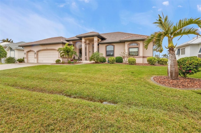 mediterranean / spanish-style house with a garage and a front lawn