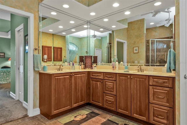 bathroom featuring ceiling fan, vanity, and a shower with door