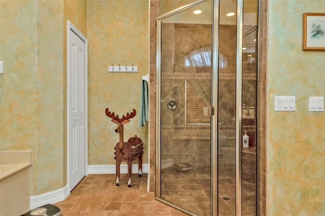 bathroom featuring a shower with door