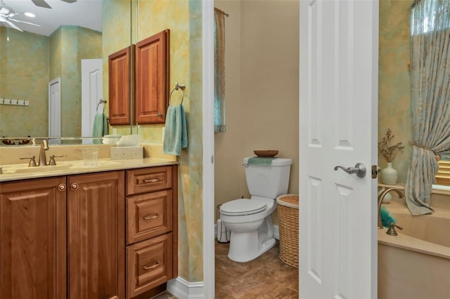 bathroom featuring a tub to relax in, ceiling fan, vanity, and toilet