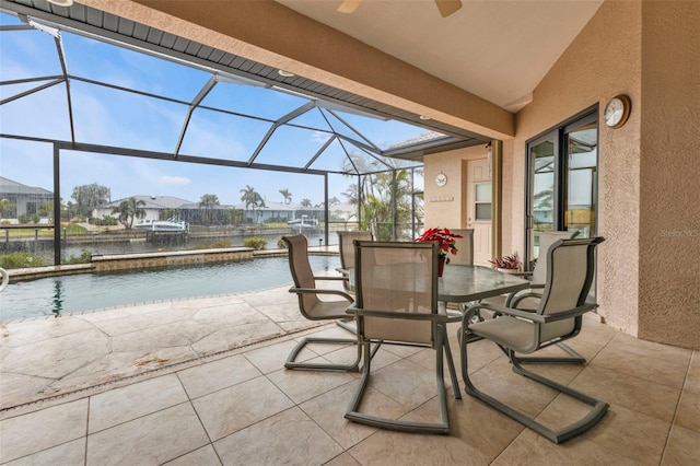 view of patio featuring glass enclosure and a water view