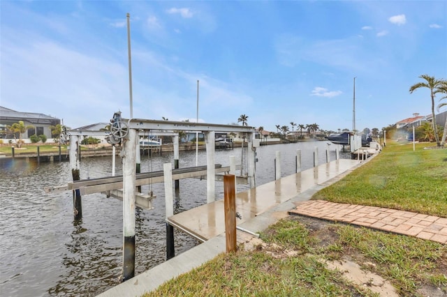 dock area featuring a water view and a yard