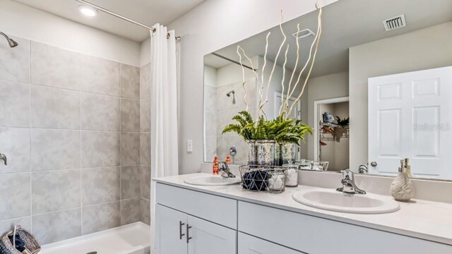 bathroom featuring walk in shower and vanity