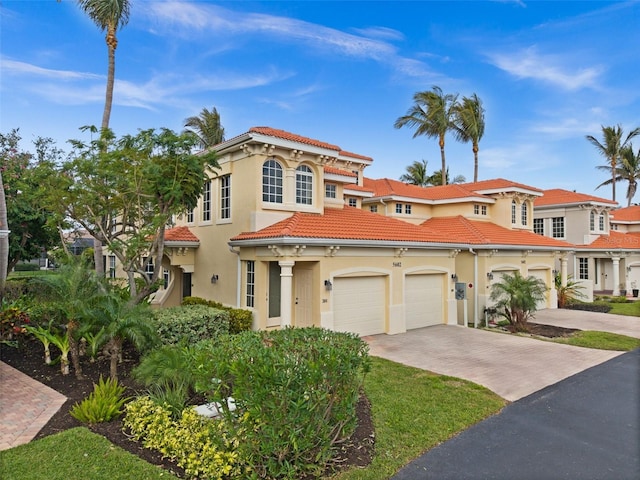 mediterranean / spanish-style house with a garage