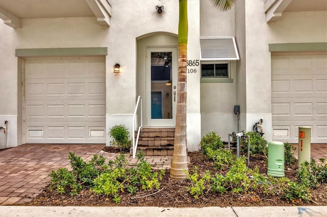 view of exterior entry with a garage