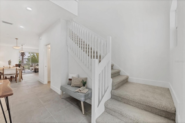 stairs featuring tile patterned flooring