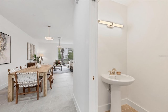 dining area featuring light tile patterned flooring and sink