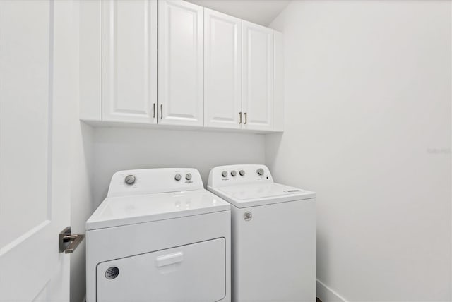 washroom with cabinets and separate washer and dryer