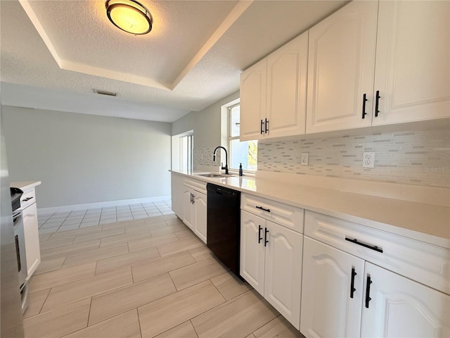 kitchen featuring tasteful backsplash, white cabinetry, dishwasher, and a sink