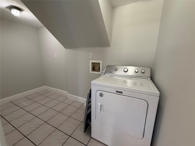 washroom featuring washer / clothes dryer, a textured ceiling, and baseboards