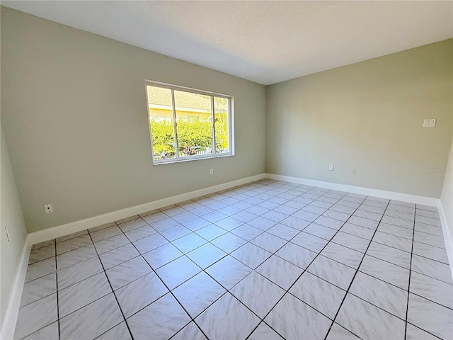 empty room featuring baseboards