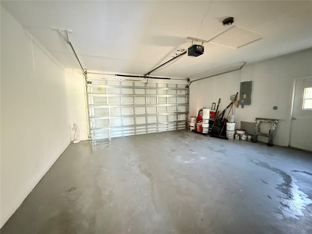 garage with electric panel and a garage door opener