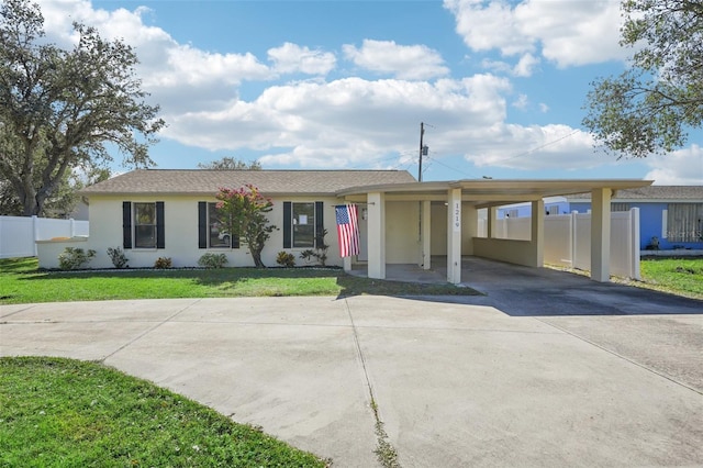 ranch-style home featuring a front yard and a carport