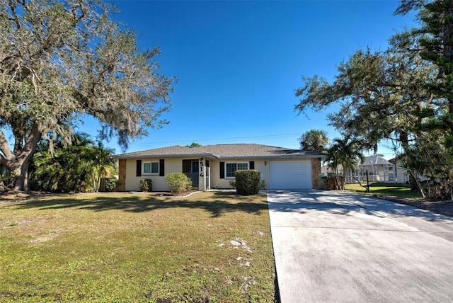 single story home featuring a garage and a front yard