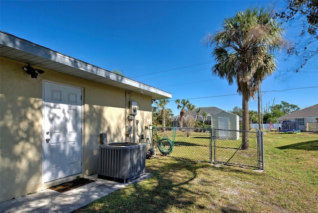 view of yard featuring central AC and a storage shed