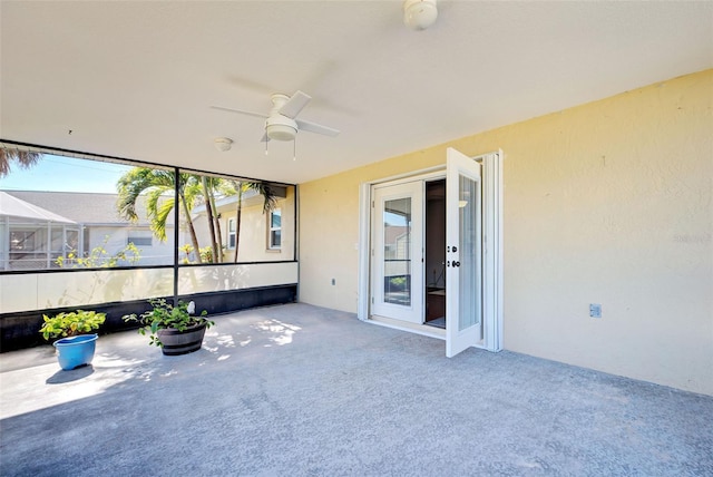 unfurnished sunroom featuring french doors and ceiling fan