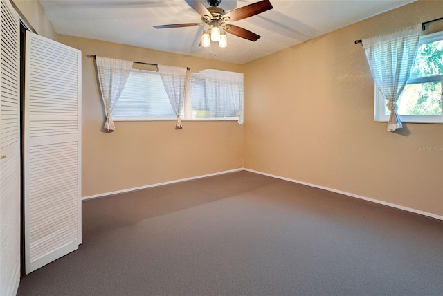 unfurnished room with carpet and ceiling fan