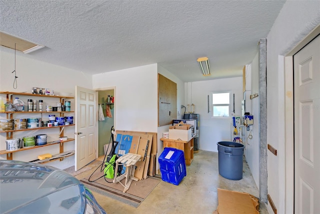 kitchen featuring water heater, a textured ceiling, and kitchen peninsula