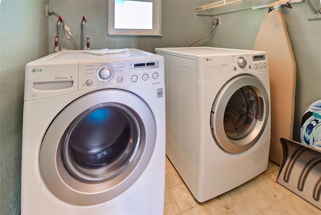 washroom featuring separate washer and dryer and light tile patterned floors