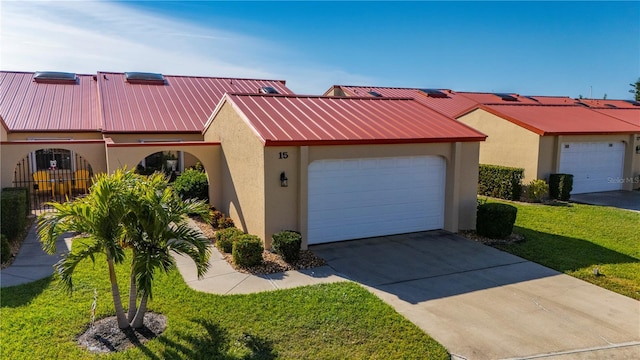 view of front of home with a garage and a front lawn