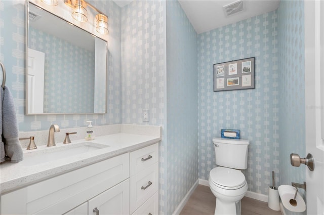 bathroom featuring vanity and toilet