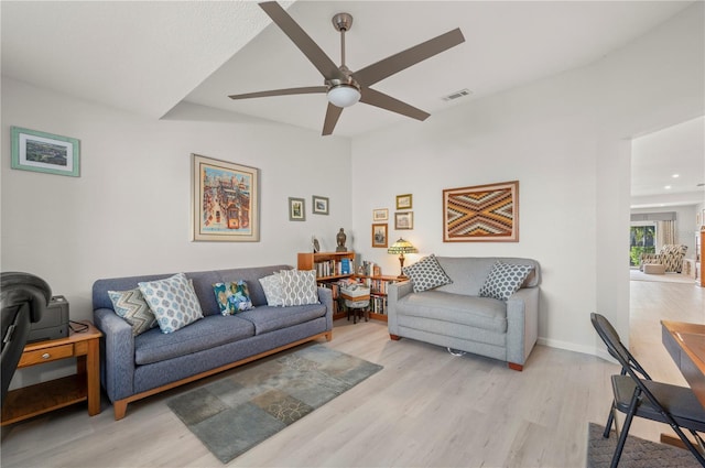 living room with ceiling fan and light hardwood / wood-style flooring