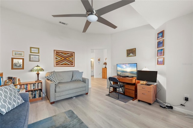 living room with light hardwood / wood-style floors and ceiling fan