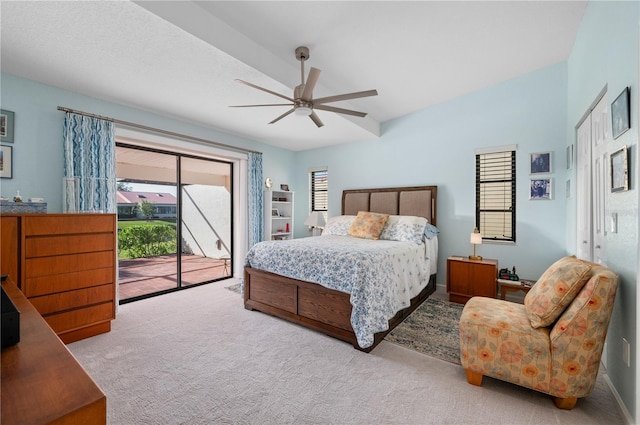 carpeted bedroom with ceiling fan and access to exterior