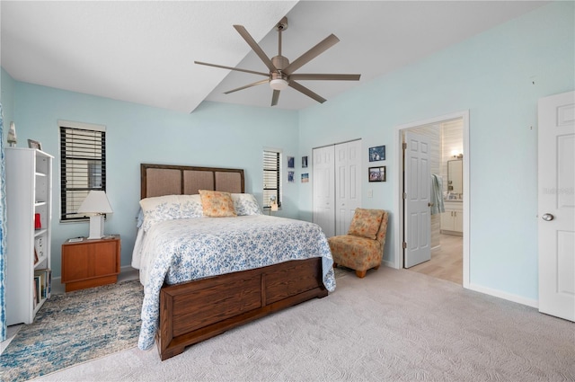 bedroom with a closet, ceiling fan, and light carpet