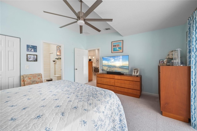 bedroom featuring ceiling fan, ensuite bathroom, a closet, and light carpet