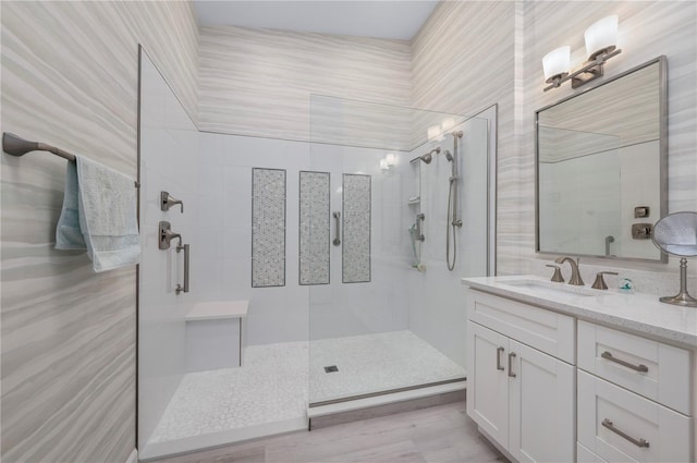 bathroom featuring vanity and a tile shower