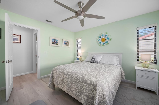 bedroom with light wood-type flooring and ceiling fan