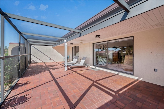 view of patio / terrace with ceiling fan and a lanai