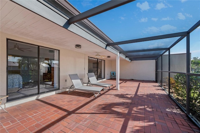 view of patio featuring glass enclosure