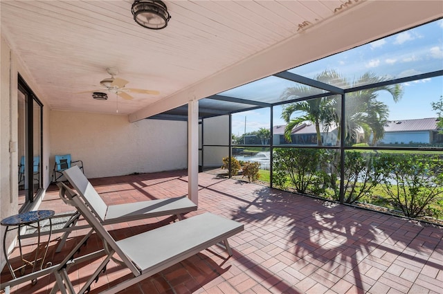 view of patio featuring ceiling fan and a lanai