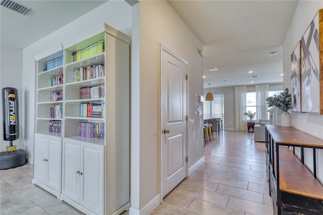 hallway with a textured ceiling