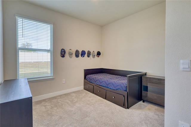 bedroom featuring light colored carpet