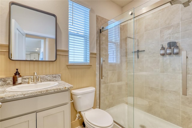 bathroom with walk in shower, vanity, and toilet