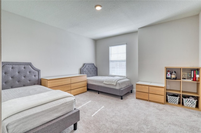 carpeted bedroom featuring a textured ceiling