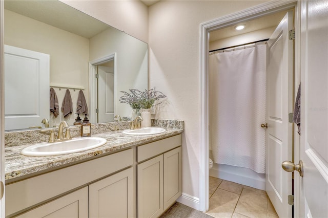 full bathroom with shower / tub combo with curtain, vanity, toilet, and tile patterned flooring