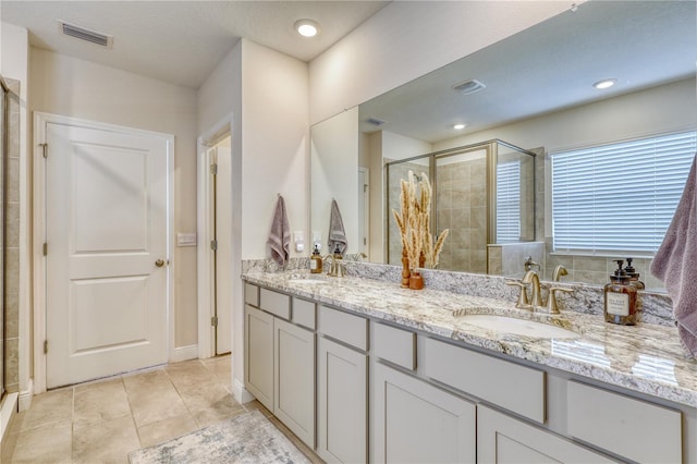 bathroom featuring walk in shower, tile patterned floors, and vanity