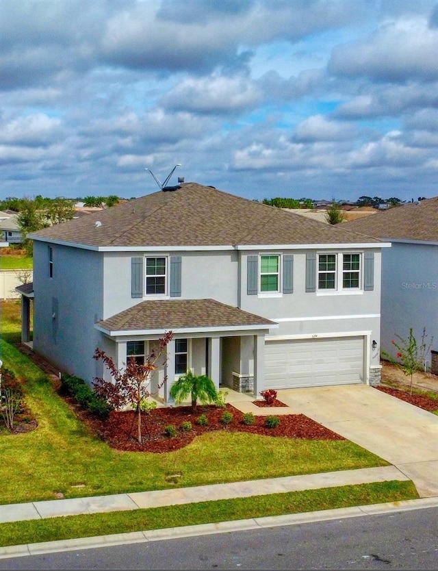 view of front of property with a garage and a front yard