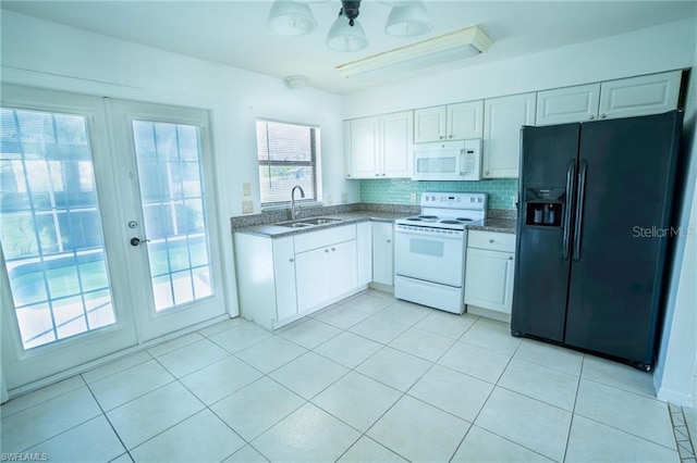 kitchen with backsplash, sink, white appliances, and white cabinets