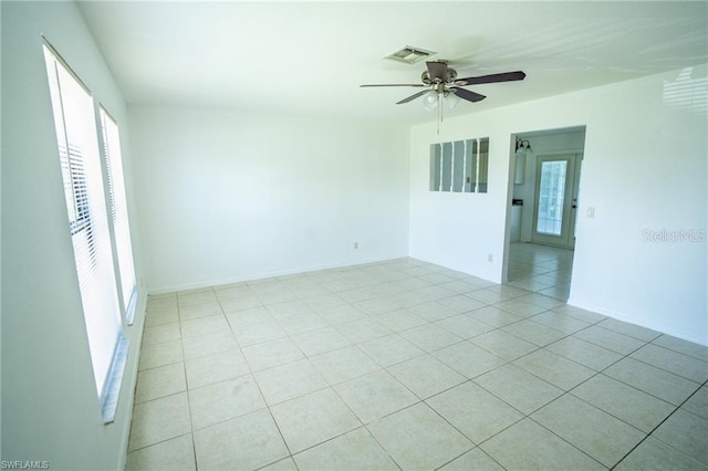 tiled empty room with ceiling fan