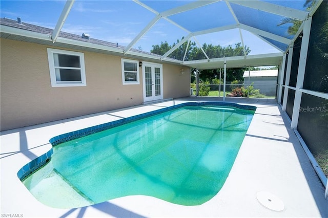 view of swimming pool featuring french doors and a lanai